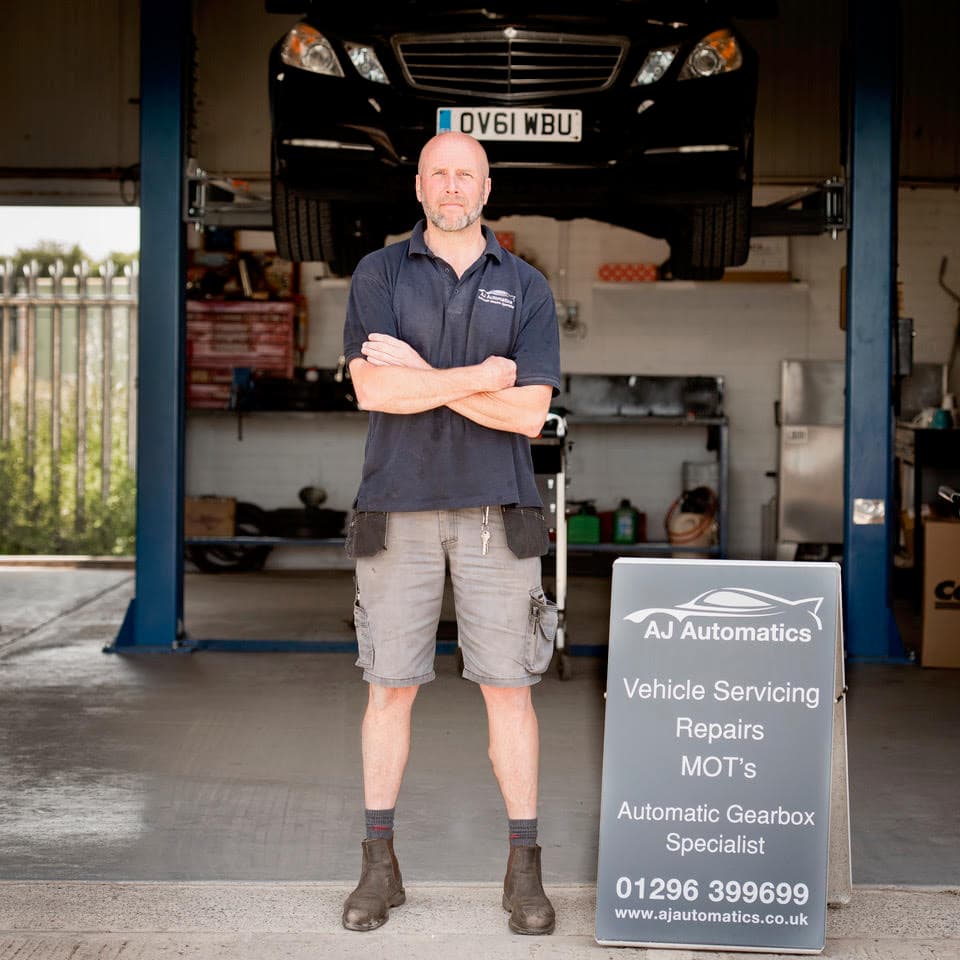 Mechanic working on a vehicle at AJ Automatics